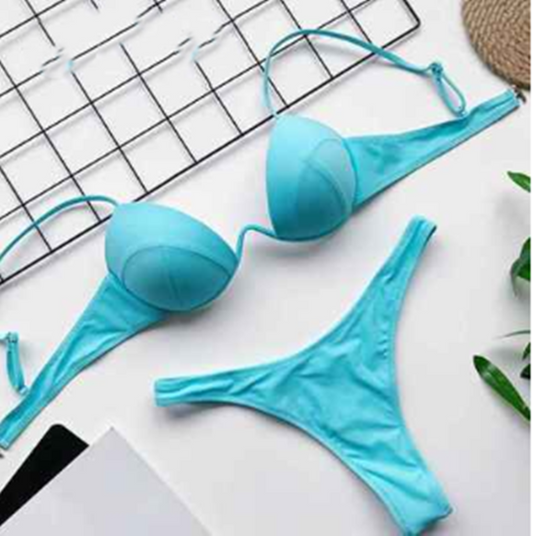 White two-piece bikini set with a push-up top and thong bottom, made of polyester, laid flat on a white surface. - Image 2