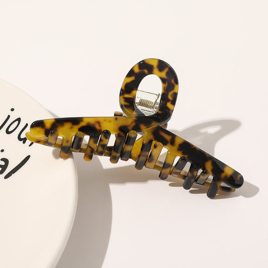 Light gray and white marbled acetate hair claw clip with a simple design, featuring a gold-toned spring. - Image 2