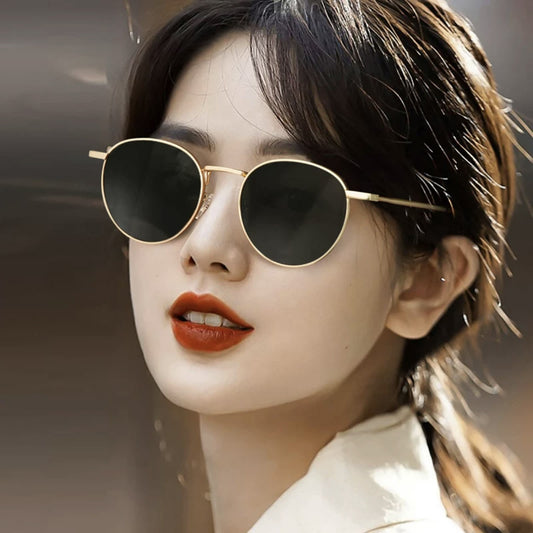 Round red lens sunglasses with a gold metal frame and black temple tips on a white background. - Image 2