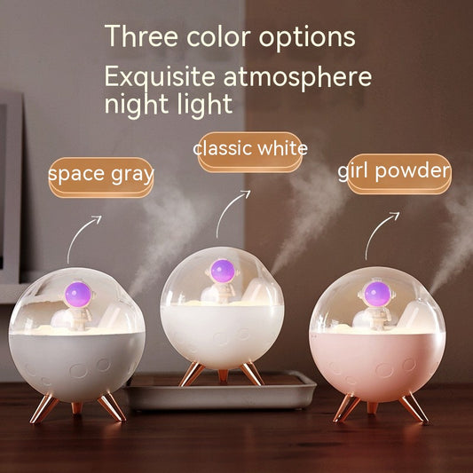 Space gray spaceman humidifier with a clear dome, glowing purple astronaut figurine, and warm yellow night light. - Image 2