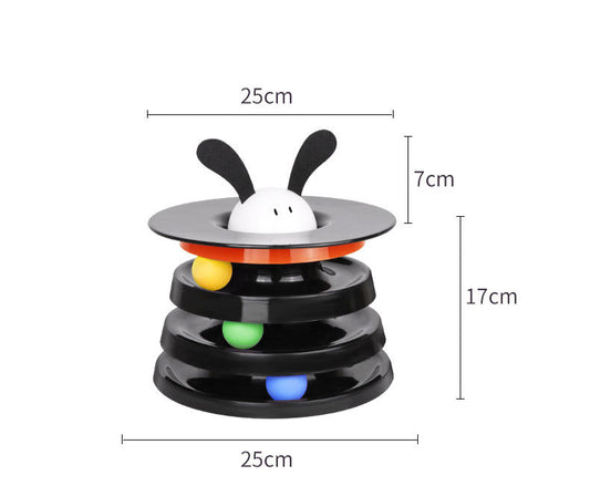 Brown tabby cat sniffing a black and orange multi-level rotating cat plate toy with colorful balls and bunny ears. - Image 2