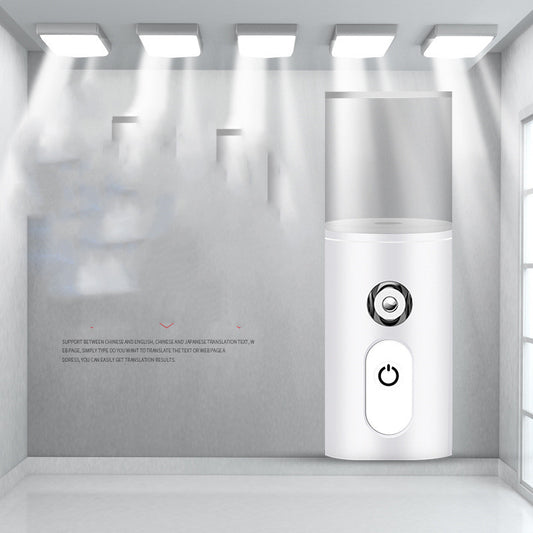 White portable facial humidifier with a clear water tank and a power button, for on-the-go moisturizing. - Image 2