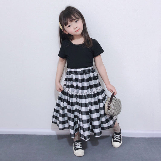 Matching black and white gingham two-piece outfits, one adult and one child size, with black short-sleeve tops and tiered skirts. - Image 2