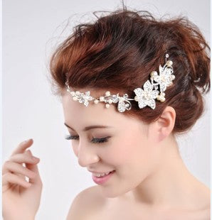 Elegant bridal jewelry set featuring a pearl and rhinestone floral necklace with matching drop earrings on a model. - Image 2