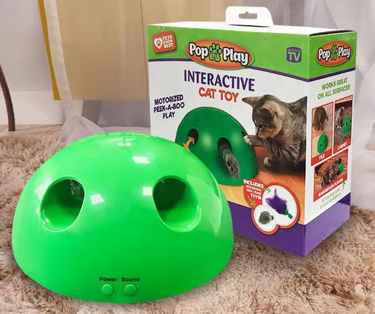 A cute tabby and white kitten with green eyes playing with a bright green dome-shaped interactive cat toy. - Image 2