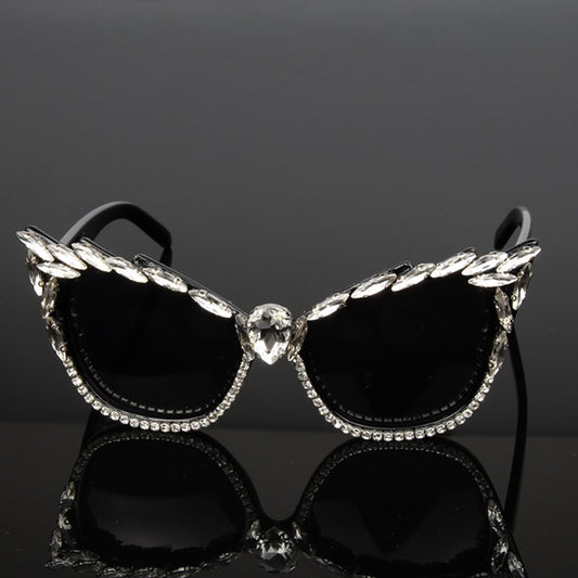 Black cat-eye sunglasses with clear rhinestones along the frames and a large teardrop rhinestone at the bridge. - Image 2