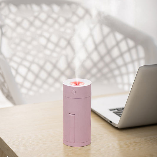 White cylindrical USB desktop humidifier with a mist outlet and a circular control button on top. - Image 2