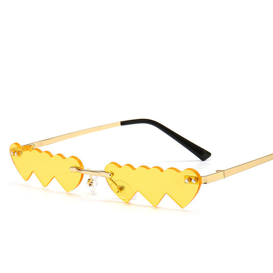 Women's rimless sunglasses with unique heart-shaped black lenses and gold-colored metal temples. - Image 2