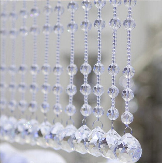 Clear faceted crystal ball bead, possibly K9 crystal, with a hole for stringing, against a dark background. - Image 2