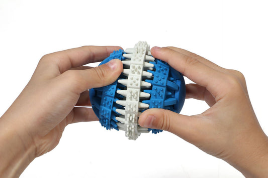 Orange and white rubber pet toy ball with textured surface for teeth cleaning and food dispensing. - Image 2