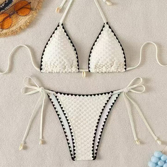 Black textured bikini with white scalloped trim, halter top, and tie-side bottoms featuring small shell details. - Image 2