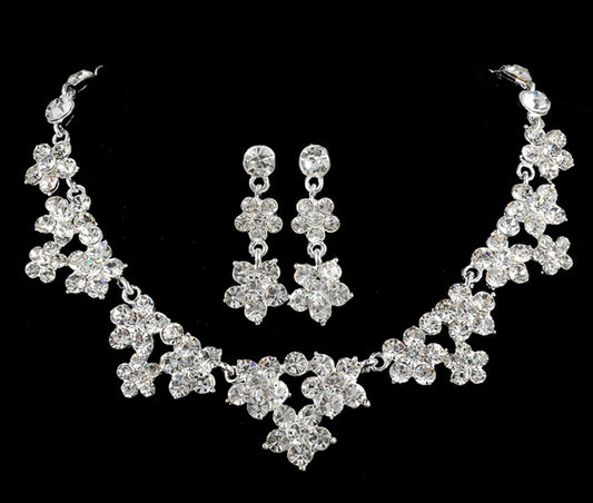 Sparkling crystal bridal jewelry set with floral necklace, drop earrings, and a matching tiara on a bride. - Image 2