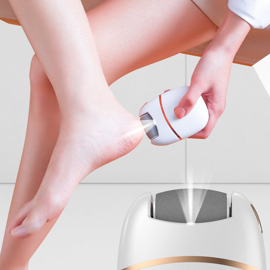 White and gold electric foot callus remover with a roller head, a replacement roller, cleaning brush, and USB cable. - Image 2