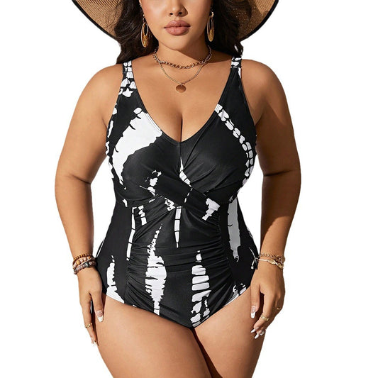 Plus size black and white tie-dye one-piece swimsuit with a V-neck and ruched detailing, worn by a model. - Image 2