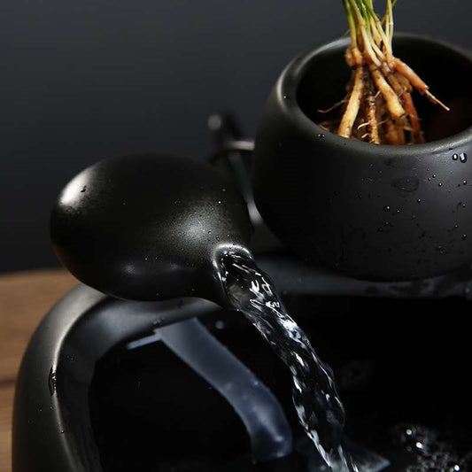 White ceramic flowing water fountain ornament with an integrated planter holding a green plant. Features gold Chinese characters. - Image 2