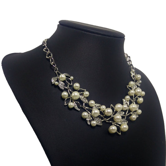 Gold-toned necklace and matching earrings set with faux pearls and clear rhinestones in an elegant leaf and vine design. - Image 2