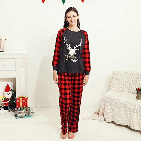 Woman wearing a Christmas pajama set with a dark gray 'Merry Christmas MOMMY' reindeer top and red and black plaid pants. - Image 2