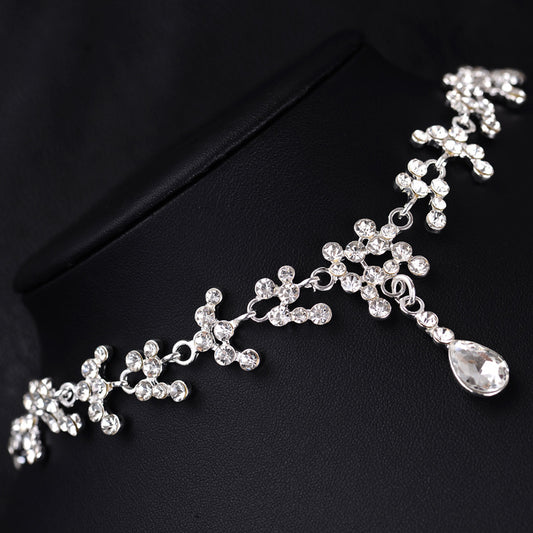 Silver-tone bridal necklace and drop earrings set with clear rhinestones and teardrop faux diamonds. - Image 2