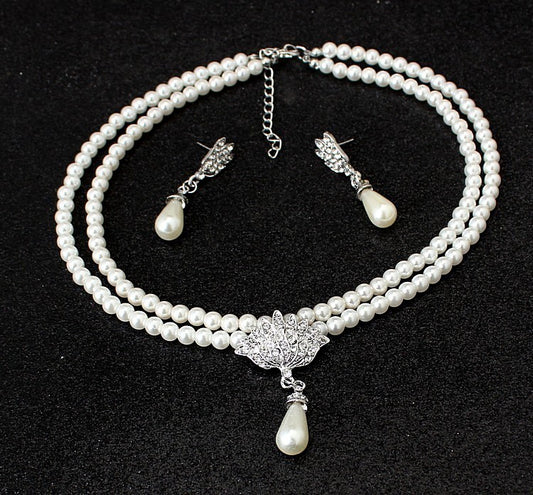 Two-strand faux pearl necklace with a rhinestone lotus pendant and matching teardrop pearl dangle earrings. - Image 2