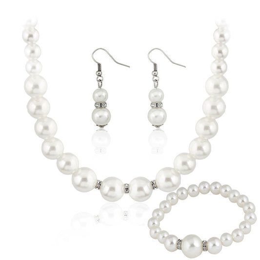 Three-piece white faux pearl jewelry set with rhinestone accents, including a necklace, drop earrings, and a bracelet. - Image 2