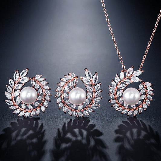Elegant pearl and cubic zirconia jewelry set with a necklace and two earrings, featuring a wreath design. - Image 2