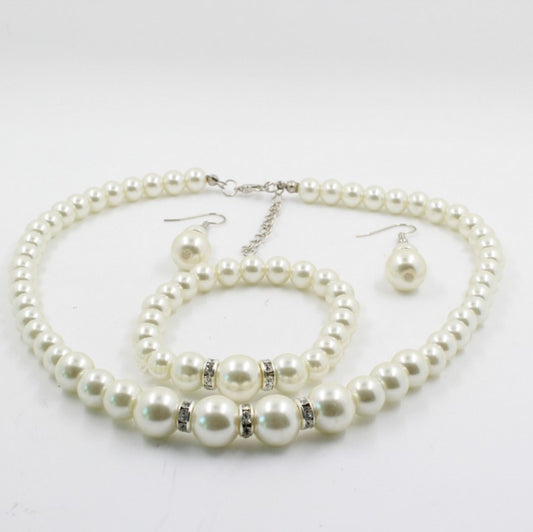Off-white pearl necklace, matching drop earrings, and bracelet set with rhinestone accents for bridal wear. - Image 2