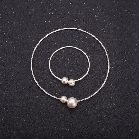 Elegant silver-tone choker necklace with a single row of clear rhinestones and two white faux pearls of varying sizes. - Image 2