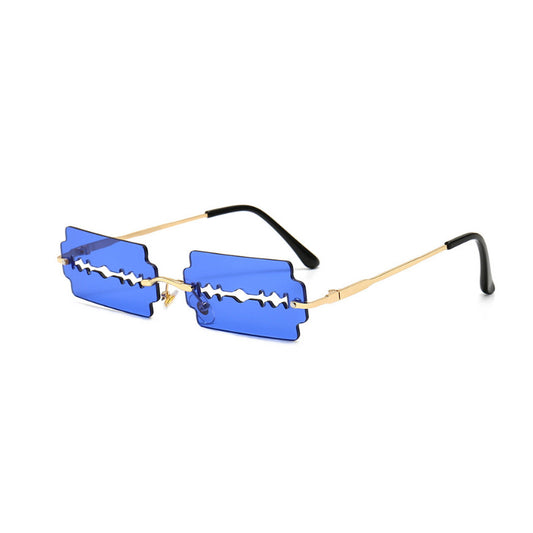 Orange razor blade shaped rimless sunglasses with gold metal frames and black ear tips on a white background. - Image 2