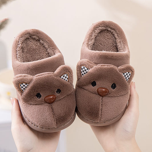 Pair of gray plush bear slippers with checkered ears and brown noses, held up against a soft background. - Image 2