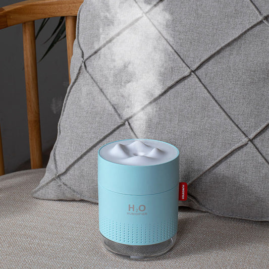 White cylindrical USB charging desktop humidifier with a clear base and a textured snow mountain top. Features 'H₂O HUMIDIFIER' text and a red tag. - Image 2