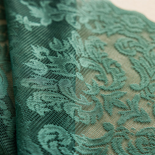 Close-up of a dark green lace curtain with an intricate floral and scrollwork pattern on sheer polyester fabric. - Image 2