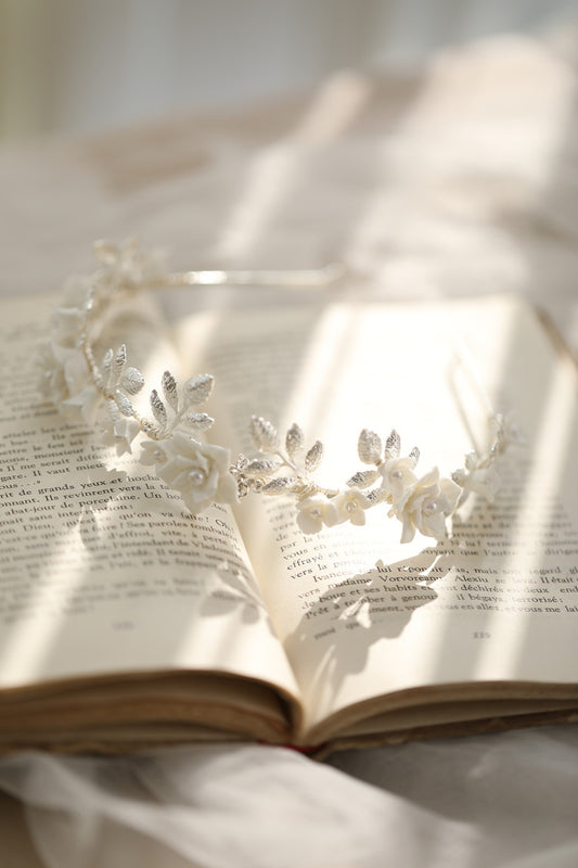 Silver-toned hair band with white ceramic flowers, faux pearls, and delicate silver leaves, perfect for bridal wear. - Image 2