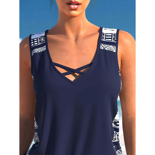 Women's navy blue tankini swimsuit with geometric pattern, criss-cross V-neck, and matching swim shorts. - Image 2