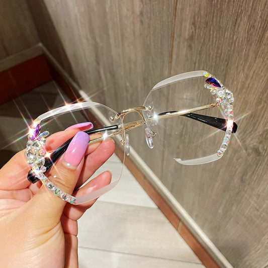 Women's frameless sunglasses with brown gradient lenses and colorful rhinestone embellishments on gold metal temples. - Image 2
