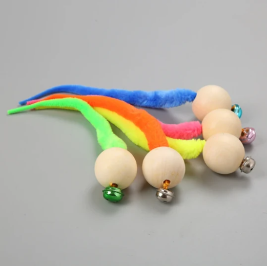 Orange plush cat toy with a wooden ball and a small golden bell, designed for cats to play and nibble. - Image 2