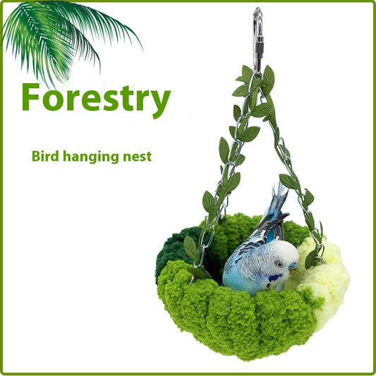 Small forest style plush bird hammock in green and yellow, hanging from a chain with artificial leaves. - Image 2