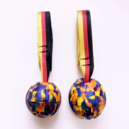 Yellow EVA pet training ball with a black, red, and yellow striped tether, designed for water play. - Image 2