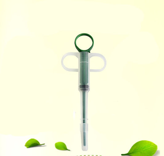 Pet feeding kit with a green syringe-style feeder and two clear teats, packaged for dogs and cats. - Image 2
