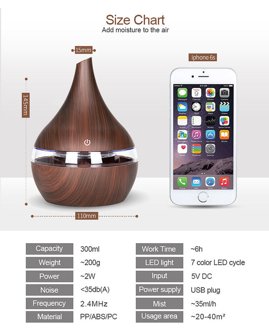 Dark wood grain LED essential oil diffuser with a blue light band and touch switch, shown with a hand operating it. Includes a bundle of 10 white filter sticks. - Image 2