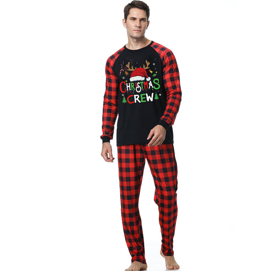 Man wearing a Christmas pajama set with a black long-sleeve top and red and black buffalo plaid pants. - Image 2