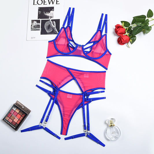 Hot pink mesh lingerie set with black trim, featuring a strappy cut-out bra and matching garter belt with panties. - Image 2