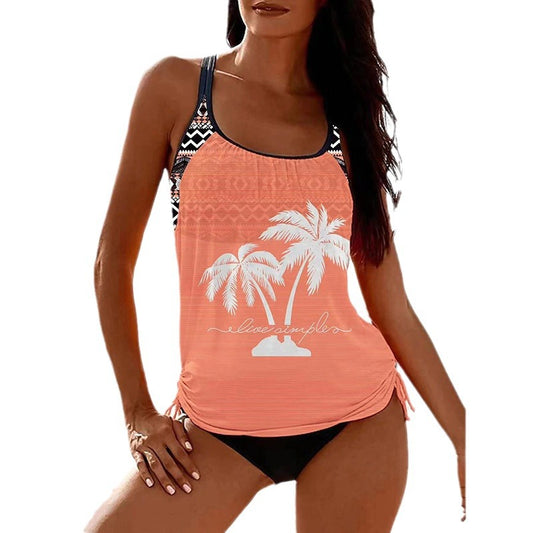 Olive green tankini top with white palm trees and 'live simple' text, paired with black swim bottoms on a beach. - Image 2