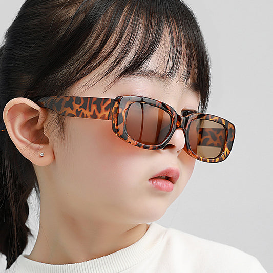 Children's small frame oval sunglasses with a solid white PC frame and brown AC lenses for UV protection. - Image 2