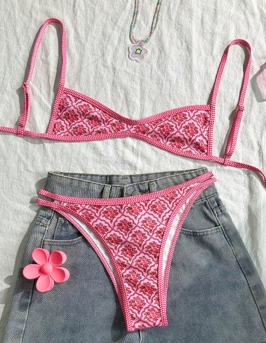 Pink two-piece bikini with a red floral and geometric print, featuring a bandeau top and high-cut bottoms. - Image 2