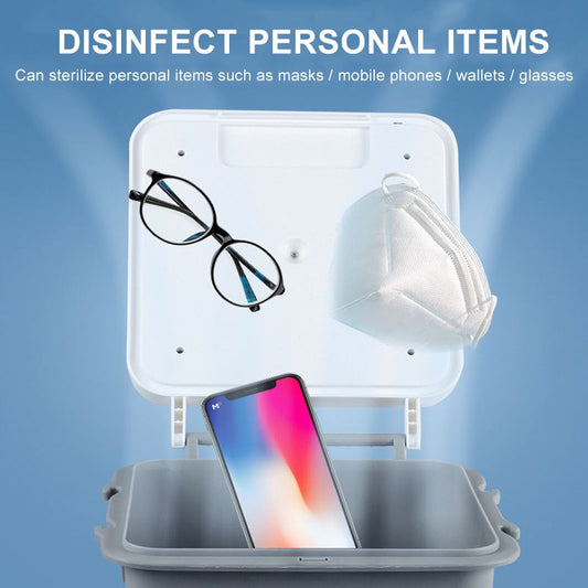 Gray UV sterilization box with an open lid, containing underwear, next to a stack of colorful folded garments. - Image 2