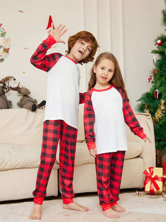 Woman wearing a red and black plaid Christmas pajama set with a white raglan long-sleeve top and matching pants. - Image 2