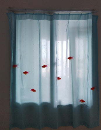 DIY goldfish curtain kit with sheer blue fabric panels, beaded wires, and red goldfish decorations hanging in a window. - Image 2