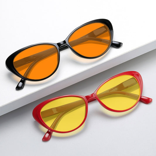 Retro cat-eye sunglasses with bright black frames and yellow night vision lenses on a white background. - Image 2
