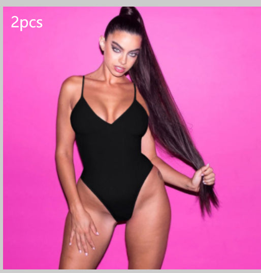 Woman modeling a fuchsia one-piece swimsuit with thin spaghetti straps and a scoop neck, featuring a high-cut leg. - Image 2