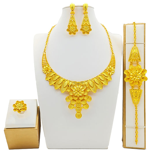Women's four-piece gold-tone jewelry set with floral designs, including a necklace, bracelet, ring, and earrings. - Image 2